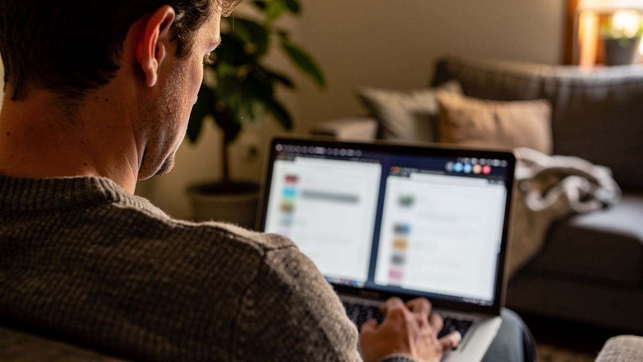 Person comparing two browser windows on a laptop